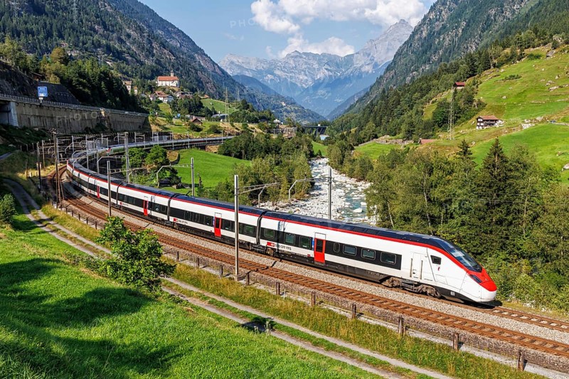 Railway passenger train type Stadler Giruno of the Swiss Federal Railways SBB on the Gotthard railway in the Alps in Wassen, Switzerland, Europe