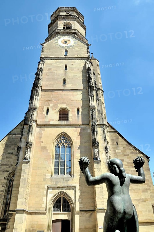 The collegiate church is the oldest Protestant church in Stuttgart and one of the city's landmarks. The female figure on the fountain holds two grape vines in her hands as a gesture of harvest blessing and thanksgiving, Stuttgart, Baden-Württemberg, Germany, Europe