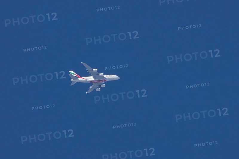 Airbus A380 jet aircraft of Emirates airlines flying in a blue sky England, United Kingdom, Europe