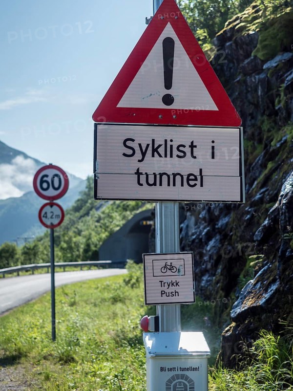 Warning system to show if cyclists are cycling in the next unlit tunnel, if button is pressed light signal flashes, Senja island, Norway, Europe