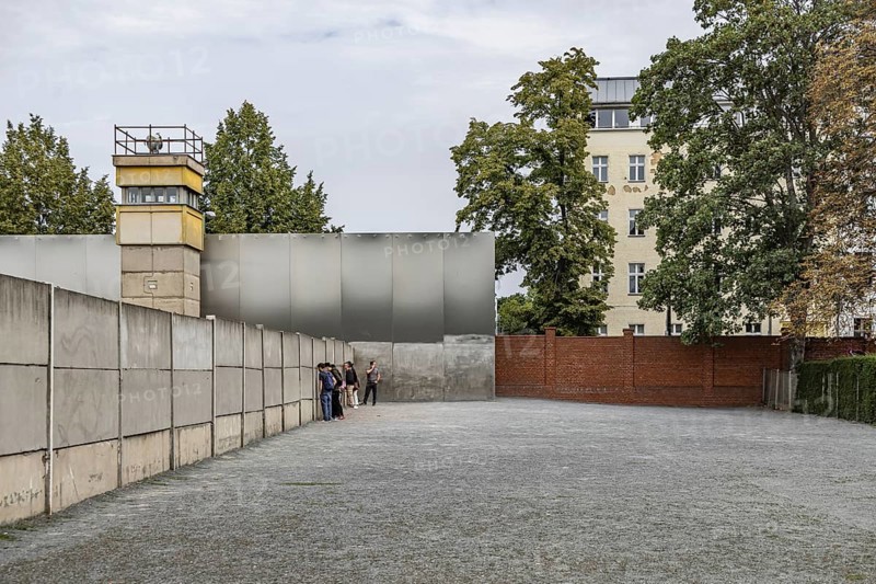 Berlin Wall Memorial, sight and reminder of the division by the Berlin Wall and of the fatalities at the border. Original preserved border strip with watchtower on Bernauer Strasse, Berlin, Germany, Europe