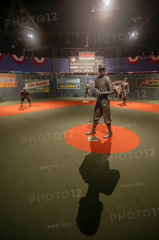 Kansas City, Missouri - The Negro Leagues Baseball Museum preserves the history of African-American baseball players, who were shut out of Major League Baseball until 1947. A statue of pitcher Satchel Paige in on a baseball field with other Negro Leagues stars.