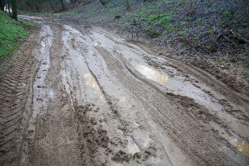Waterlogged muddy unsurfaced road after heavy rain in Suffolk, England, United Kingdom, Europe