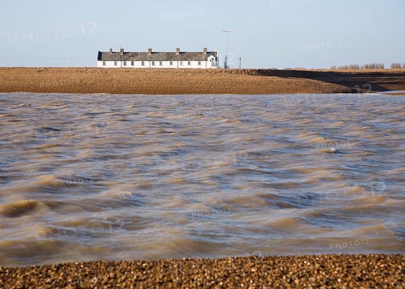 White terrace of Coastguard Cottages, beach and sea viewed from offshore, Shingle Street, Suffolk, England, United Kingdom, Europe