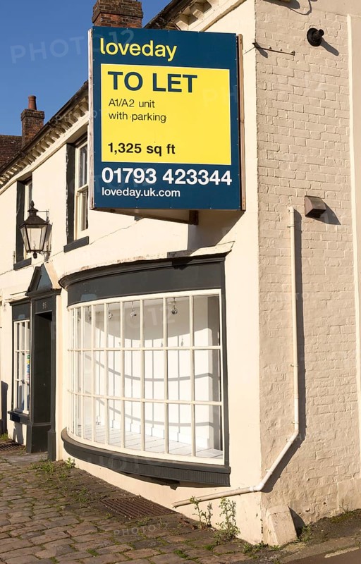 Loveday estate agent To Let sign commercial shop property, High Street, Marlborough, Wiltshire, England, UK