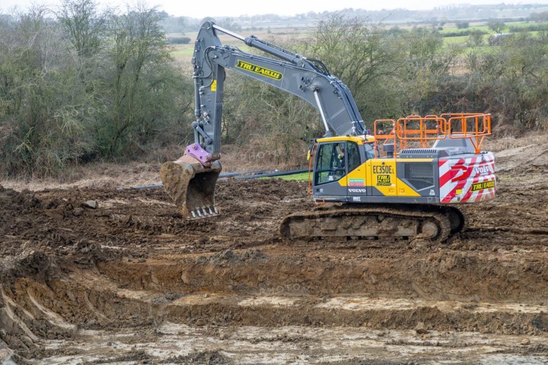 TRU PLANT hire Volvo excavator heavy plant machinery constructing new reservoir, Shottisham, Suffolk, England, UK