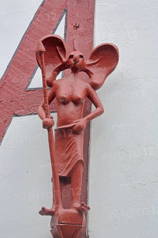 Red sculpture with spear at the Hensler bakery, female figure with large ears, modern art, arts and crafts, Kolpingstraße, Old Town, Limburg, Hesse, Germany, Europe