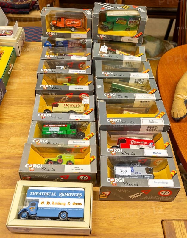 Boxes of Corgi model trucks, vans and other vehicles on display at auction, UK