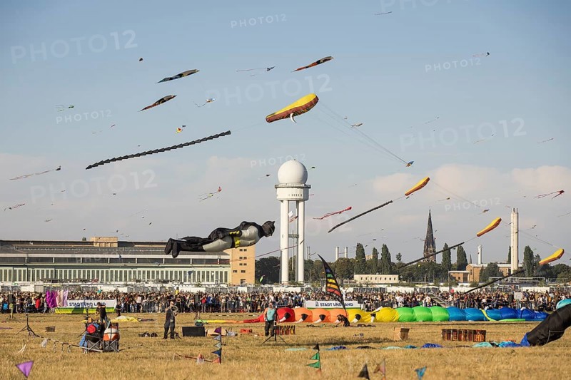 Flying kite in the shape of Batman in front of the tower at the kite festival on Tempelhofer Feld in Berlin on 21/09/2024