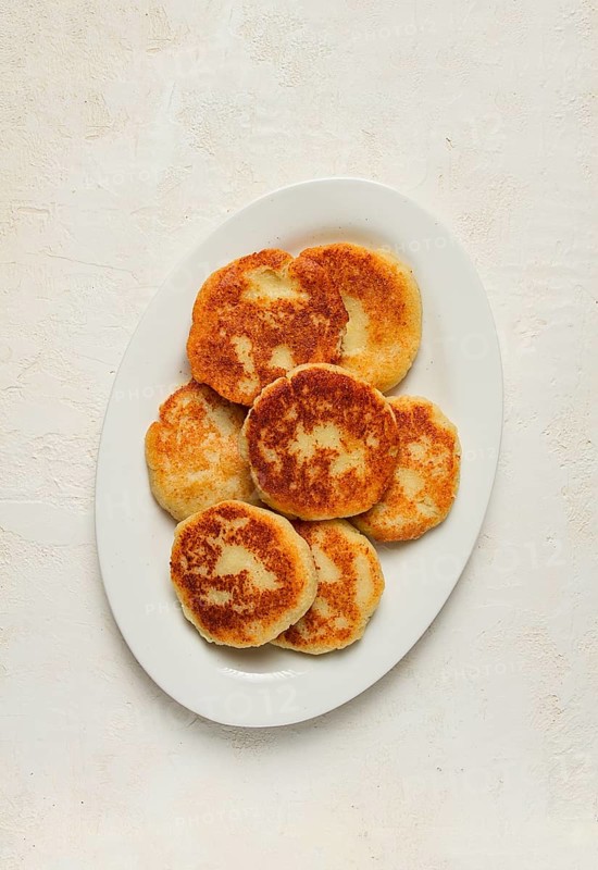 Chvishtari, corn flour tortillas with cheese, pastries, Georgian cuisine, Mchadi, homemade, top view, on a wooden table, no people