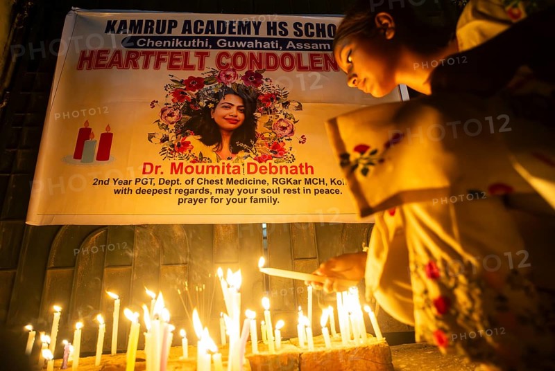 Students light candles as they pay tribute to a victim of rape and murder of a doctor inside a hospital in Kolkata, on August 18, 2024 in Guwahati, India. A trainee doctor, 31, was attacked at RG Kar Medical College and Hospital in Kolkata, the capital of West Bengal, last week