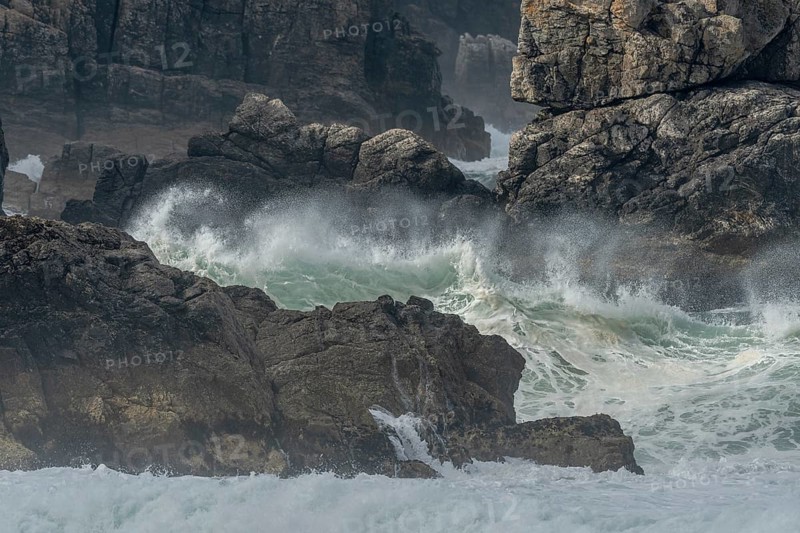 Large waves of the Atlantic Ocean crash against the rocks of a cliff. Camaret sur mer, Crozon, Finistere, Brittany, France, Europe