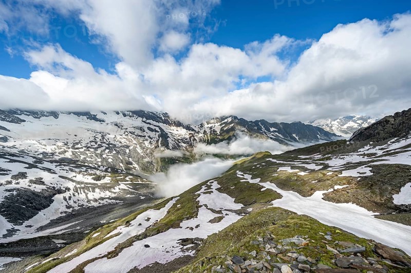 Mountain landscape with snow fields and high fog in the valley, summit Hoher Weißzint and Hochsteller with glacier Schlegeiskees, Berliner Höhenweg, Zillertal Alps, Tyrol, Austria, Europe