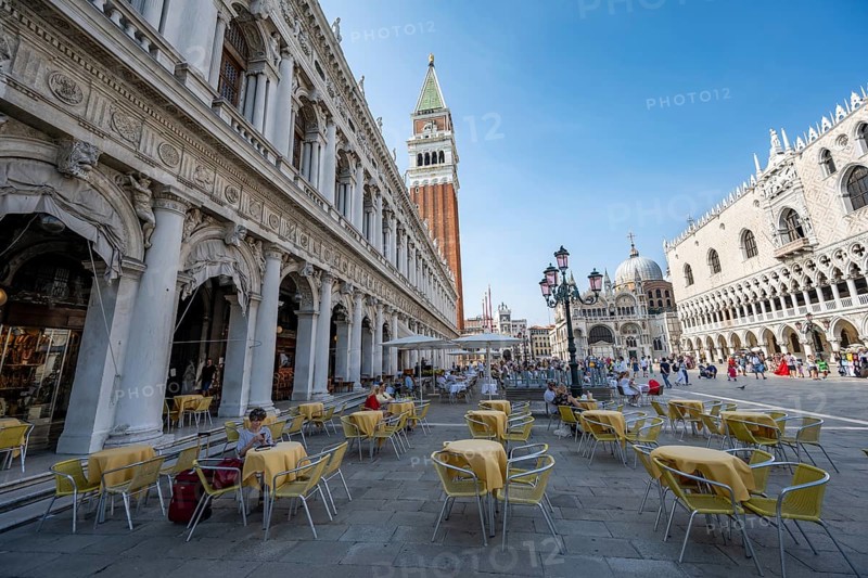Yellow chairs and tables of a café on St Mark's Square, Campanile, St Mark's Basilica and Doge's Palace, Venice, Veneto, Italy, Europe