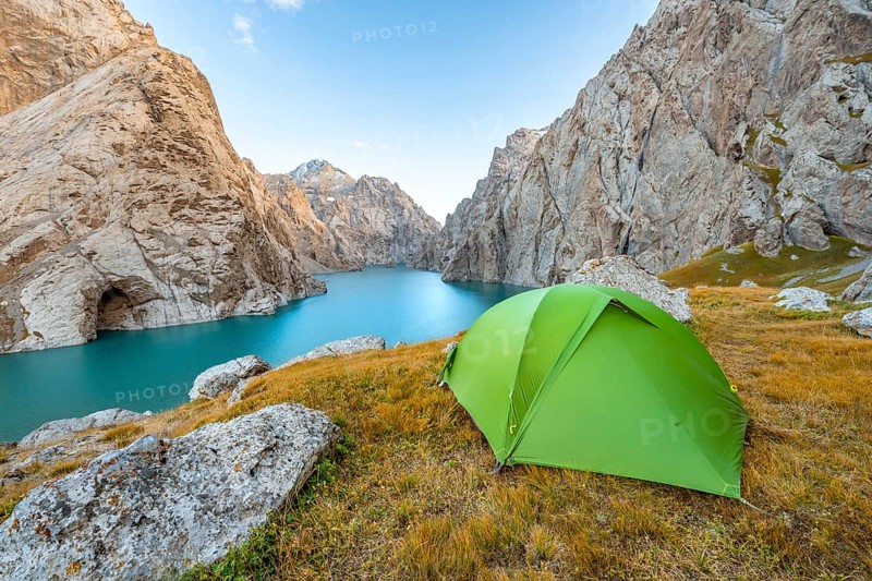 Green tent at the turquoise mountain lake Kol Suu with rocky steep mountains, Kol Suu Lake, Sary Beles Mountains, Naryn Province, Kyrgyzstan, Asia