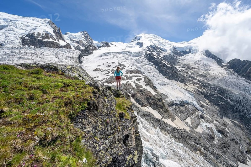 Mountaineer in front of a glacier, High alpine glaciated mountain landscape, La Jonction, Glacier des Bossons meets Glacier de Taconnaz, Summit of Mont Maudit and Mont Blanc, Chamonix, Haute-Savoie, France, Europe