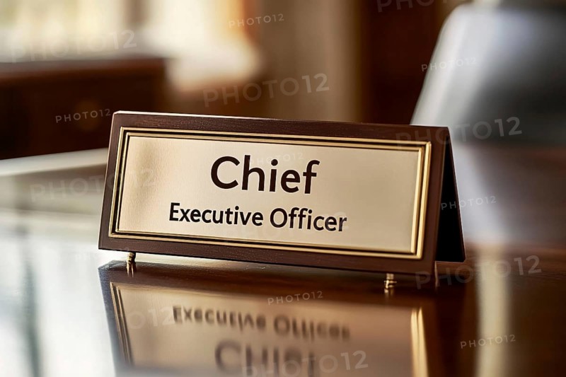 Desk sign with text 'Chief executive Officer' on desk in office. Generative Ai, AI generated