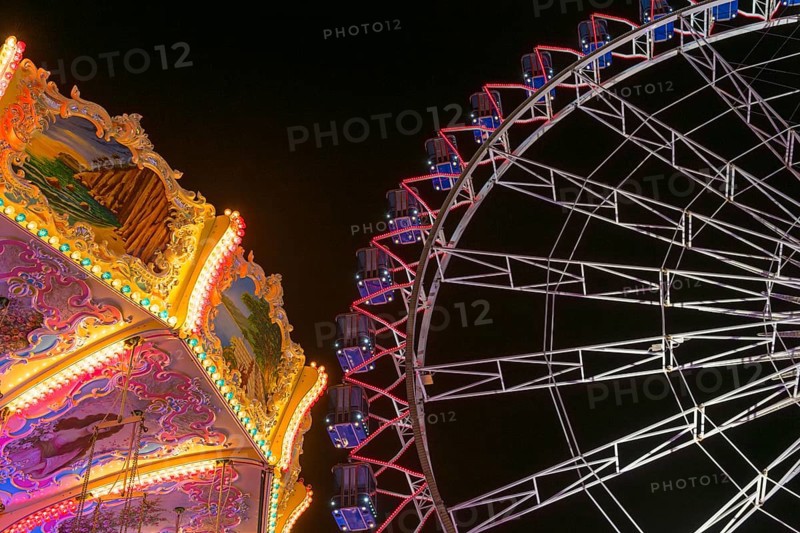 A funfair at night with illuminated chain carousel and Ferris wheel, Europa Rad, rides, wave flight, Cannstatter Wasen, folk festival, Bad Cannstatt, Stuttgart, Baden-Württemberg, Germany, Europe