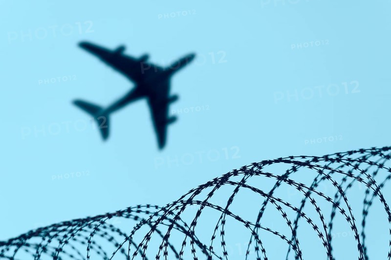 Symbolic image, deportation flights of illegal and delinquent migrants, passenger aircraft, airport, security fence, barbed wire, Germany, Europe