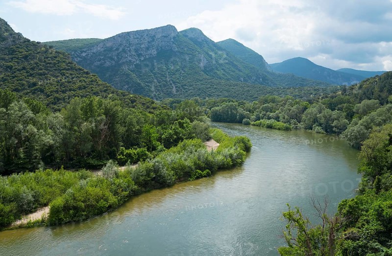 Wide view over a river flowing through a densely forested and mountainous landscape, River Nestos or Mesta, Nestos Gorge, Galani, Macedonia and Thrace, Greece, Europe