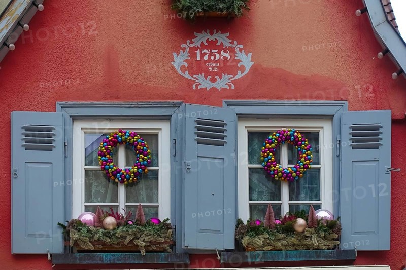 House facade with inscription built in 1758, red facade, Christmas decoration, window, window shutters, Christmas motif, Christmas, Christmas festival, Advent season, Christmas wreaths, wreath, colourful Christmas baubles, decoration, Advent season, Christmas card motif, Reutlingen, Baden-Württemberg, Germany, Europe
