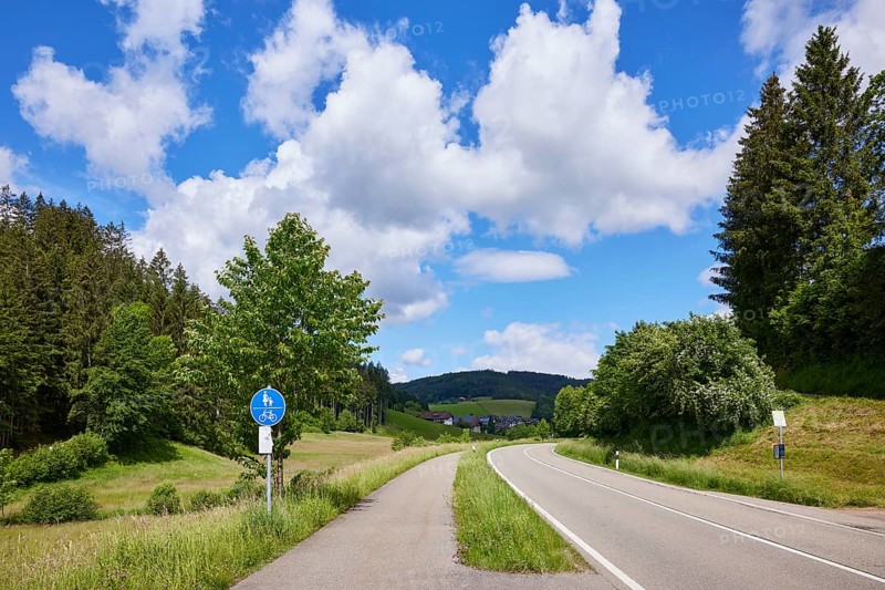 Cycle path, country road and blue sky with cumulus clouds in a landscape near Biederbach, Black Forest, Emmendingen district, Baden-Württemberg, Germany, Europe
