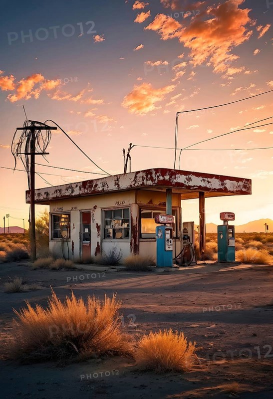 Abandoned retro gas station in the middle of a desert at sundown, with rusted gas pumps and an old sign, AI generated
