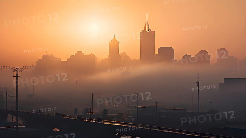 Cityscape emerging from a dense enveloping fog in sunrise and skyscrapers piercing the haze, AI generated