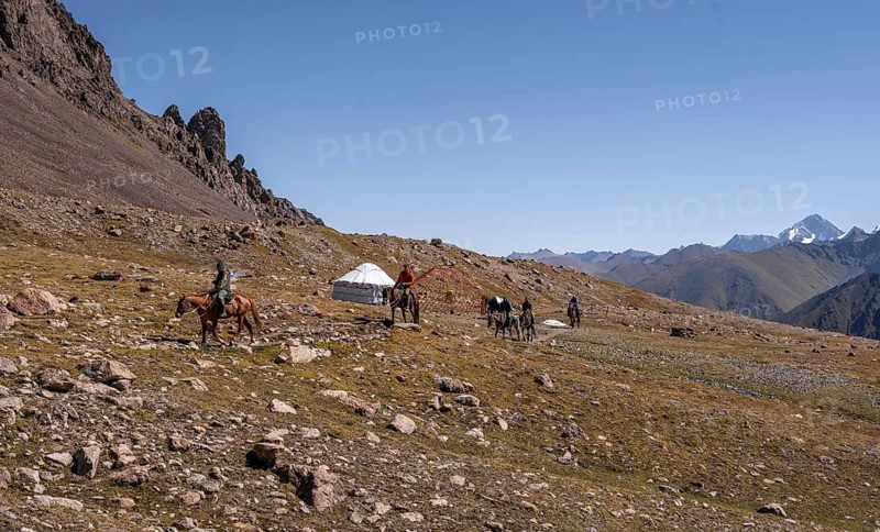 Hikers and yurts in the high valley, Keldike Valley on the way to the Ala Kul Pass, Tien Shan Mountains, Kyrgyzstan, Asia