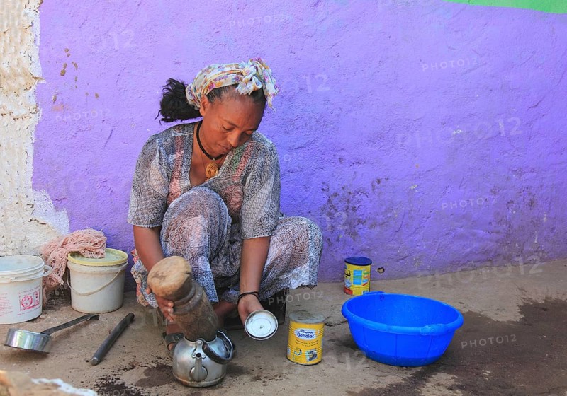 In the highlands of Abyssinia, in the village of Sina, young woman prepares coffee for the coffee ceremony, Ethiopia, Africa