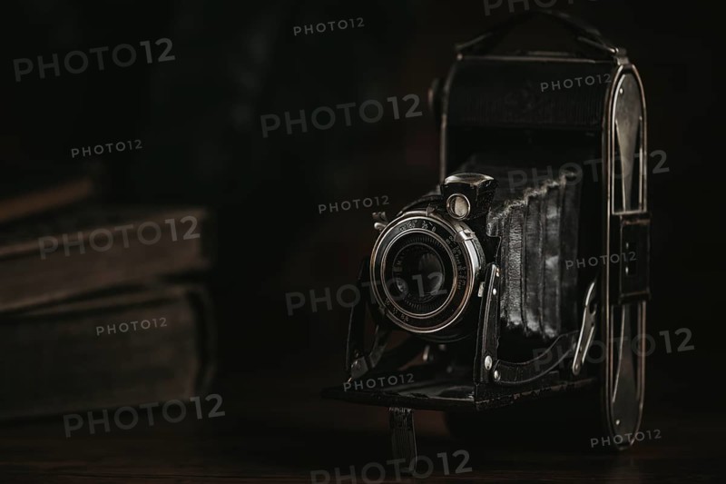 Unfolded antique bellows camera in a dark ambience