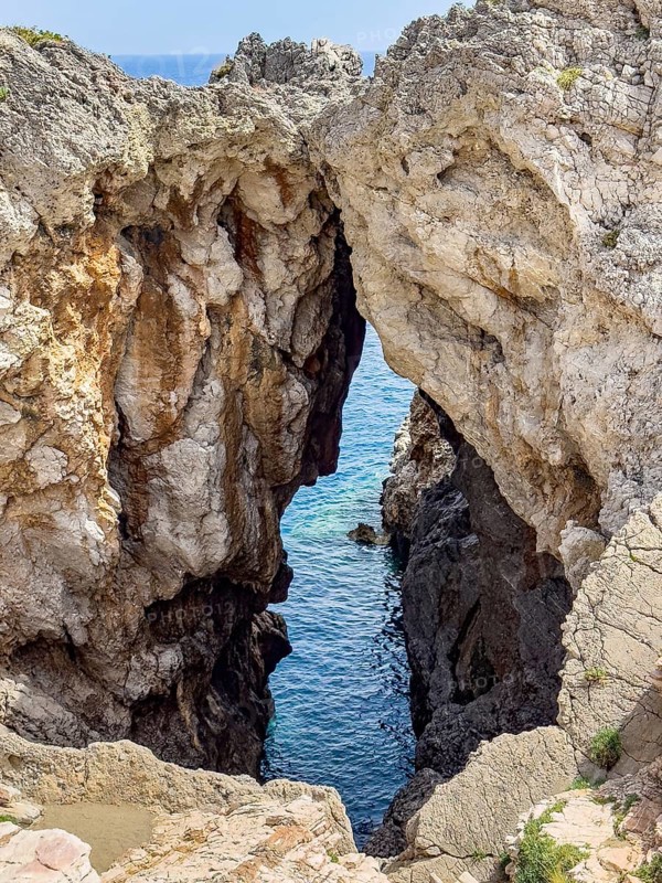 View of striking rock with narrow crevice at the exit of Avios Pavlos Bay, Agios Pavlos, Crete, Greece, Europe