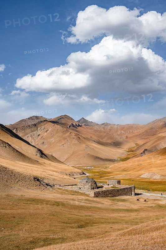 Historic caravanserai Tash Rabat from the 15th century, with yellow hills, Atbashy district in the Naryn region, Kyrgyzstan, Asia
