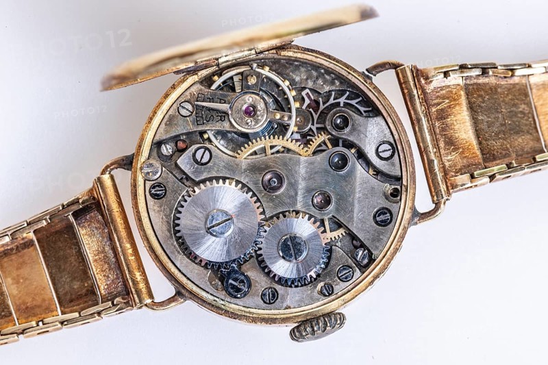 Opened old wristwatch shows the detailed inner movement