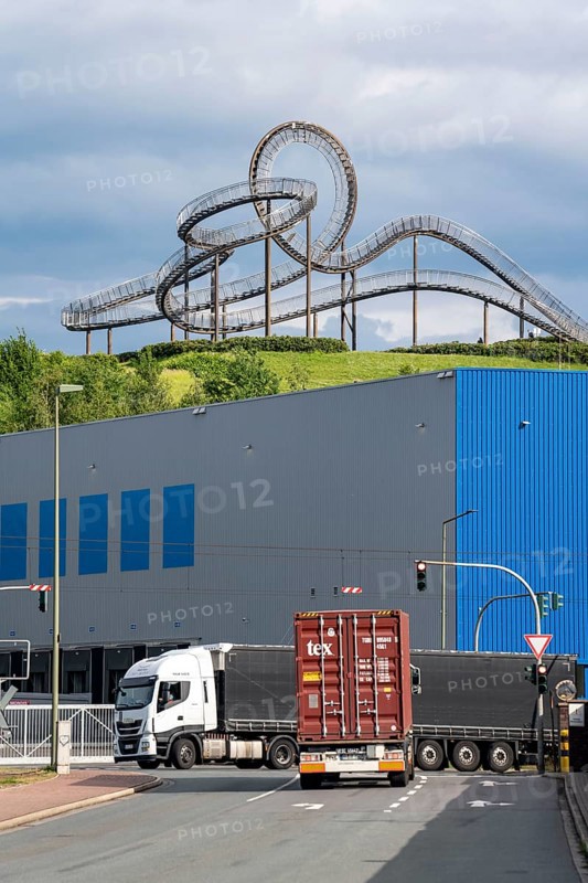 Landmark Tiger and Turtle - Magic Mountain, on the Heinrich-Hillebrand-Höhe in the Angerpark in Duisburg-Angerhausen, in front of it logistics centre, container trucks coming from the Rhein-Ruhr Container Terminal, on the Rhine North Rhine-Westphalia, Germany, Europe