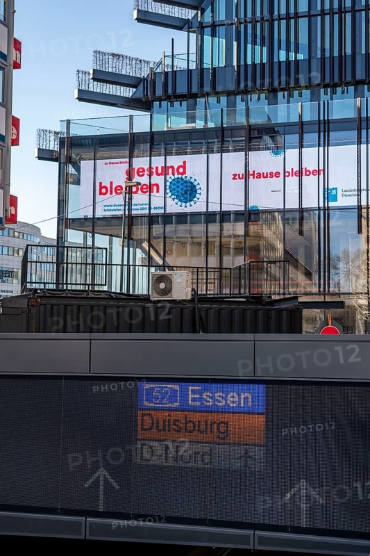 Information on corona, call to stay at home, illuminated sign, display at Kö-Bogen 2 building, effects of the coronavirus pandemic in Germany, Düsseldorf