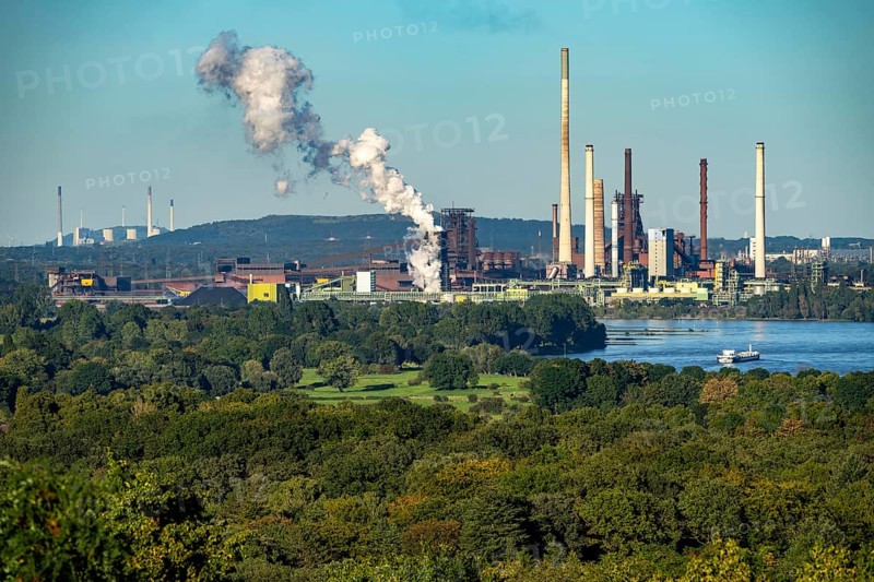 View across the Rhine to the Thyssenkrupp Steel steelworks in Duisburg-Beeckerwerth, blast furnaces, coking plant, green landscape on the left bank of the Rhine, North Rhine-Westphalia, Germany, Europe