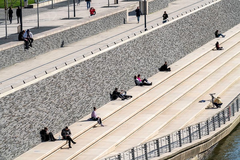 Effects of the coronavirus crisis, Rhine promenade, Rhine boulevard, on the Deutzer Ufer, few people with a lot of distance to each other in the spring sun, Cologne, Germany, Europe