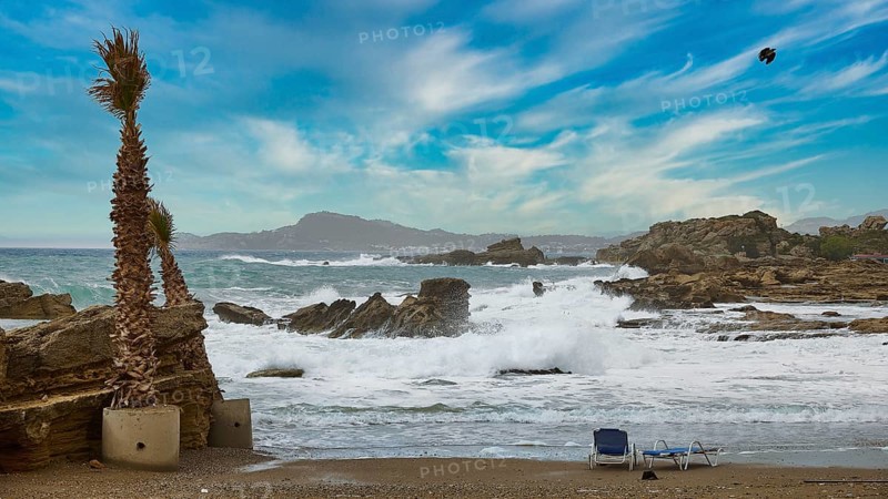 Sky replaced, Beach landscape with waves, rocks, a palm tree and a vast sky with clouds, Oasis Beach, Kallithea, Rhodes, Dodecanese, Greek Islands, Greece, Europe