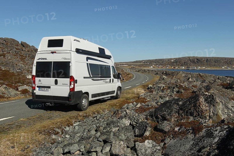 Camper/caravan on a lonely coastal road through the tundra to Hamningberg (in the background) on the Barents Sea, Lapland, Northern Norway, Norway, Scandinavia, Europe