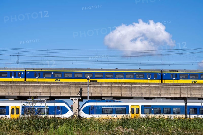 Trains of the Dutch railway, NS, Nederlandse Spoorwegen N.V., on a double-decker track, below local train Sprinter Light Train, above Intercity Direct train, near Hoofddorp, municipality of Haarlemmermeer, near Amsterdam