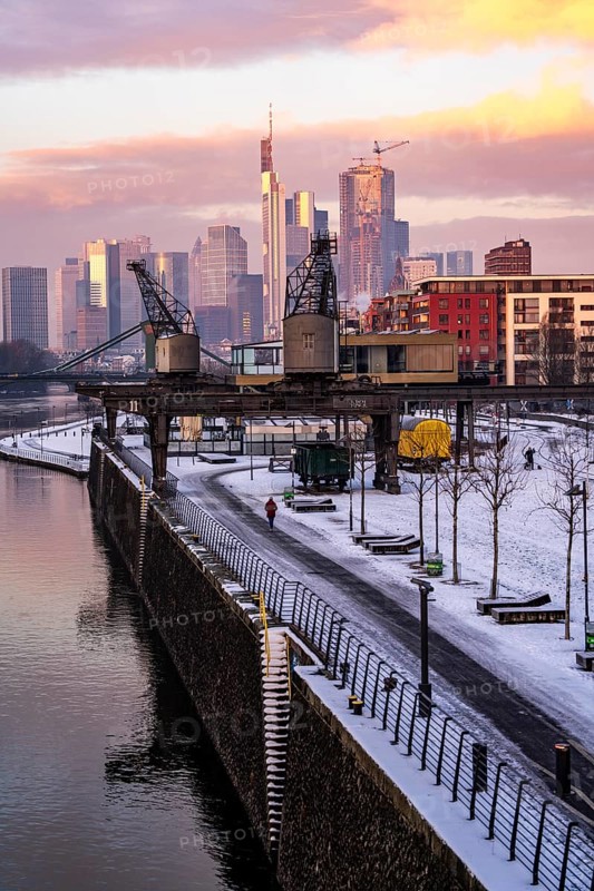 The skyline of Frankfurt am Main, skyscrapers of the banking district, historic harbour cranes at the Wesel shipyard, wintry morning, Hesse, Germany, Europe