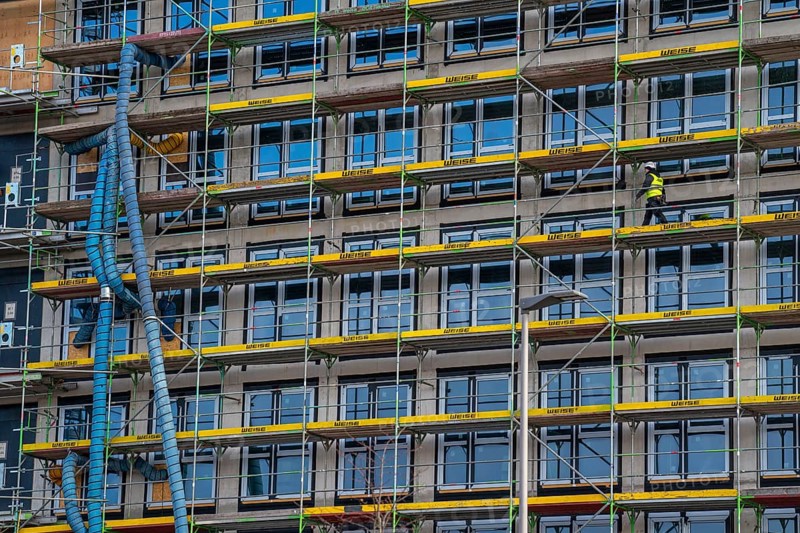 Large construction site, scaffolded shell of an office building complex, air hoses for building ventilation, heating, O-Werk Campus in Bochum, North Rhine-Westphalia, Germany, Europe