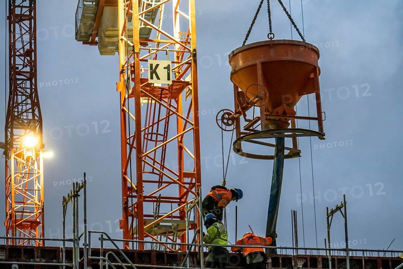 Concrete work, at dusk, on a large construction site building a residential and commercial complex, North Rhine-Westphalia, Germany, Europe