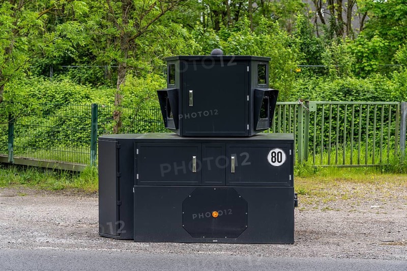 Semi-stationary speed camera on the B227, Hattinger Straße, used by the city of Gelsenkirchen, model TraffiStar S350 from Jenoptik, the device is temporary, self-sufficient for up to a week, at various measuring points, can measure and flash in 2 directions, laser measurement technology, data is sent to the city via mobile radio, is installed on a protected trailer, popularly known as an armoured speed camera, here a 50 km/h zone, North Rhine-Westphalia, Germany, Europe