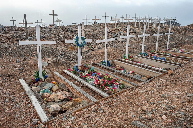 Crosses decorated with colourful flowers mark graves in a rocky area, cemetery, remote Arctic Inuit settlement Ittoqqortoormiit, Scoresbysund or Scoresby Sund or Greenlandic Kangertittivaq, East Greenland, Greenland, North America