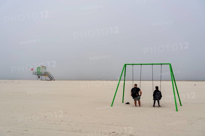 North Sea island of Langeoog, early summer, shortly after the first easing of the lockdown in the Corona crisis, foggy weather, still quite few tourists on the beach, DLRG watchtower, Lower Saxony, Germany, Europe