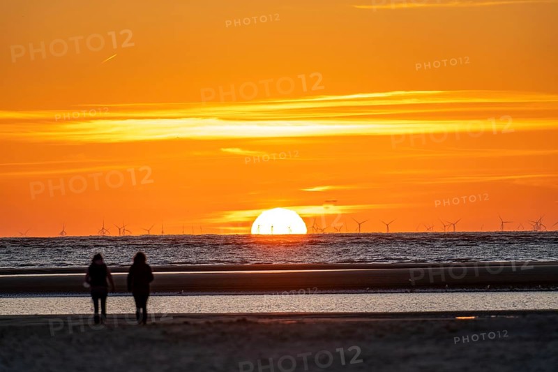 North Sea island of Langeoog, early summer, shortly after the first easing of the lockdown in the Corona crisis, still quite few tourists on the beach, offshore wind farm, sunset, Lower Saxony, Germany, Europe