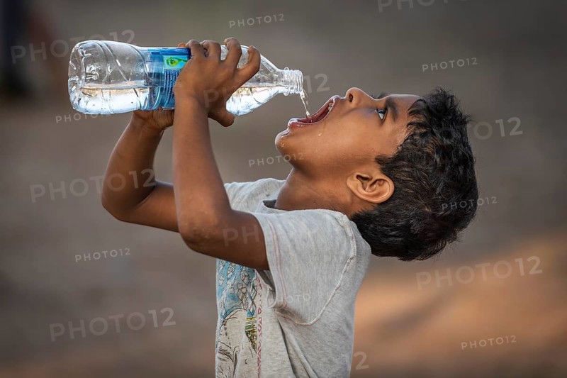 Boy drinking water from a plastic bottle, Fort Cochin, Kochi, Kerala, South India, India, Asia