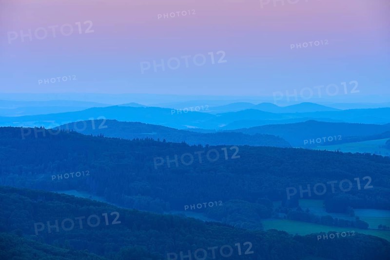 Undulating hills and mountains in blue and pink evening twilight, creating a calm and peaceful atmosphere, Abtsroder Kuppe, Abtsroda, Wasserkuppe, Rhön, Hesse, Germany, Europe